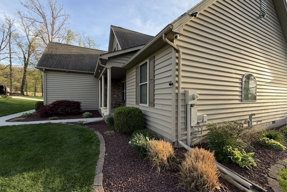 Soft wash house washing removing algae and grime from siding